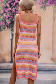 Knit midi dress with tie straps, side slit, and multicolor stripes in coral, yellow, and blue.