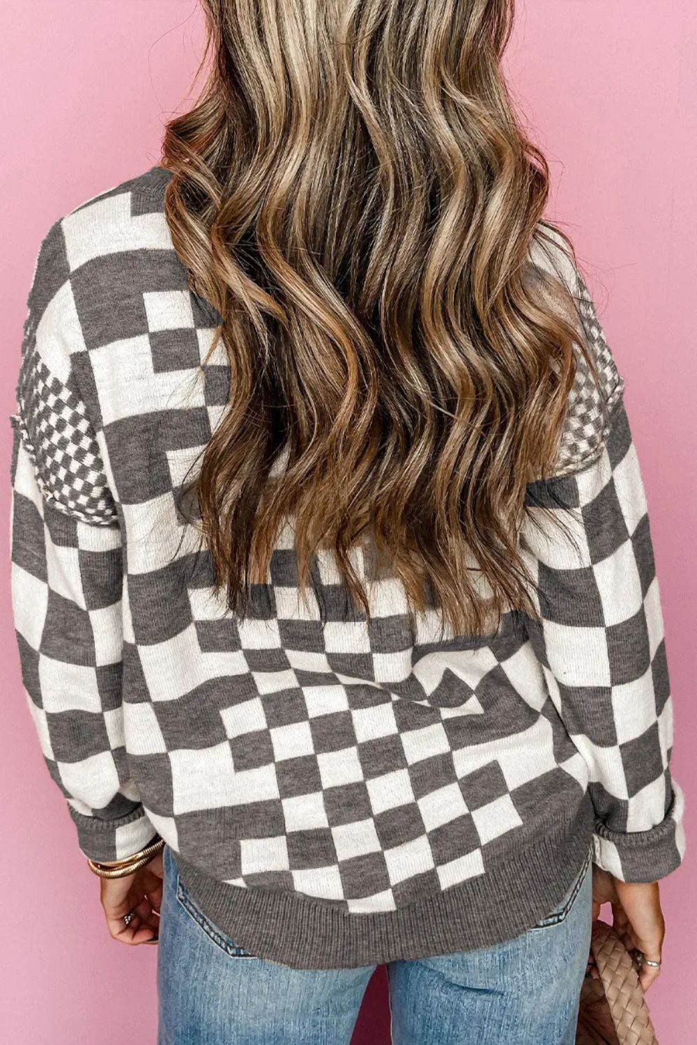 Gray and white geometric knit checkerboard pullover sweater with crew neck and long sleeves.