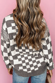 Gray and white geometric knit checkerboard pullover sweater with crew neck and long sleeves.