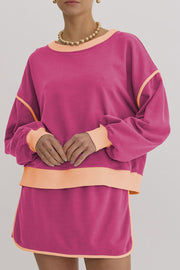 Pink sweatshirt and skort set with contrast trim and crew neck.