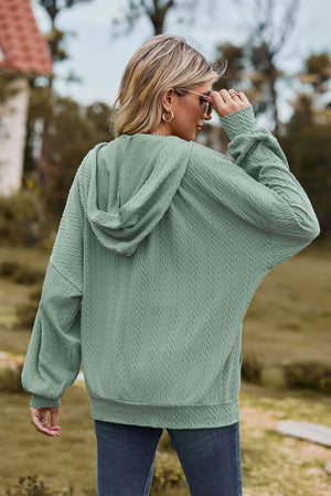 Sage textured cable knit hoodie with a hood and long sleeves.