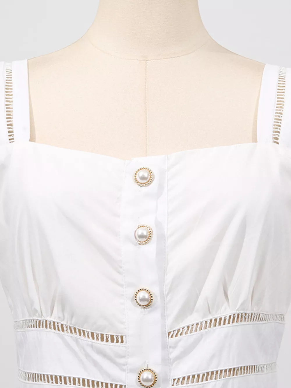 White eyelet midi dress with square neckline, pearl button front, and cutout details.
