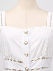 White eyelet midi dress with square neckline, pearl button front, and cutout details.
