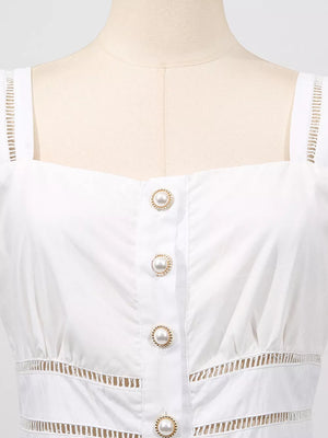 White eyelet midi dress with square neckline, pearl button front, and cutout details.