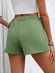 Textured utility shorts in gum leaf green with elastic waist and decorative buttons.