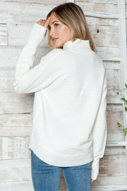 White ribbed knit funnel neck sweater with long sleeves and a relaxed fit.