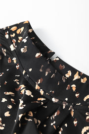Black high-neck blouse with abstract print and button detail