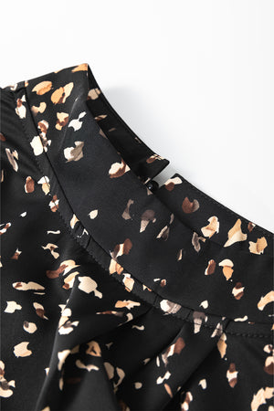 Black high-neck blouse with abstract print and button detail