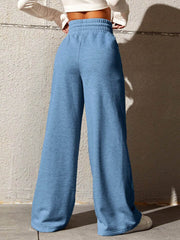 Sky blue sweatpants with a drawstring waist and wide legs.