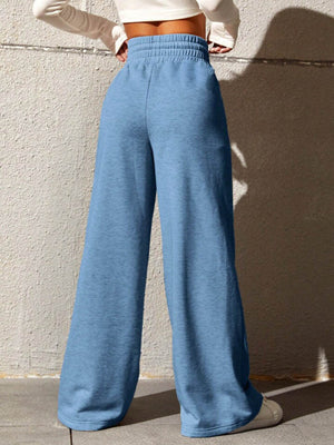 Sky blue sweatpants with a drawstring waist and wide legs.