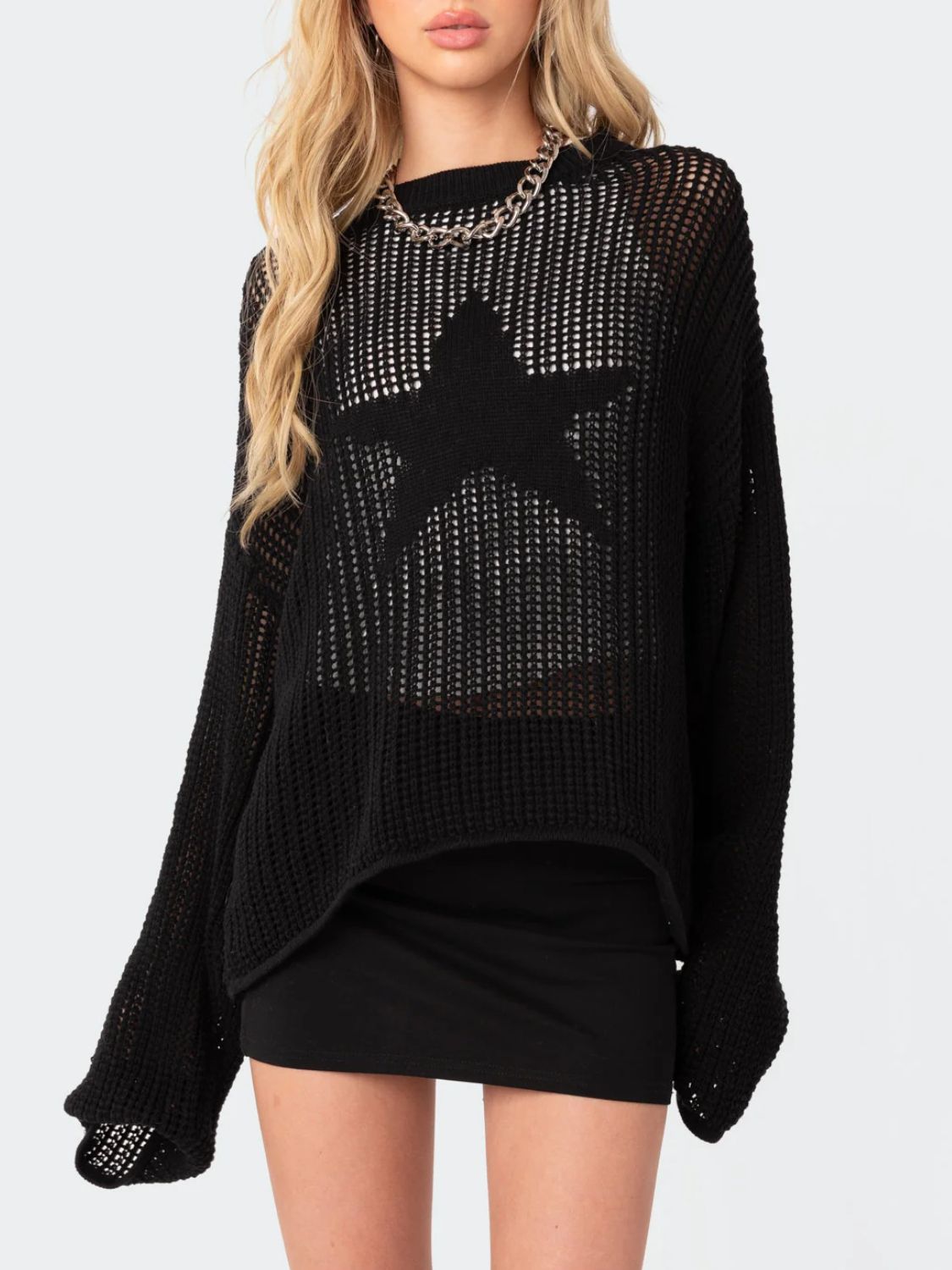 Black open knit sweater with a large star detail, crew neck, and long sleeves.