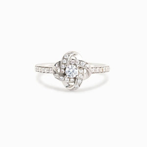 Silver ring with intertwined crystal knot design and pavé band