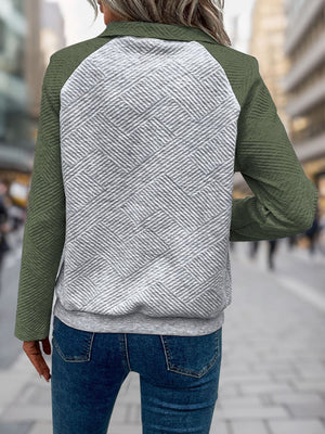 Moss green quilted raglan sweatshirt with a textured geometric pattern on the back panel.