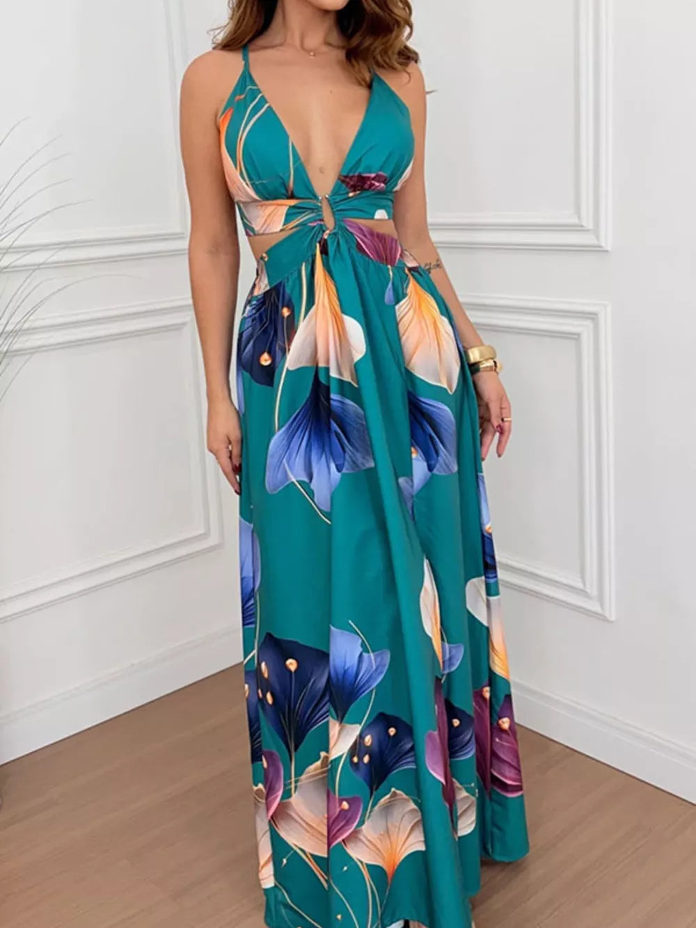 Teal floral maxi dress with cutout sides, deep V-neck and decorative ring detail.