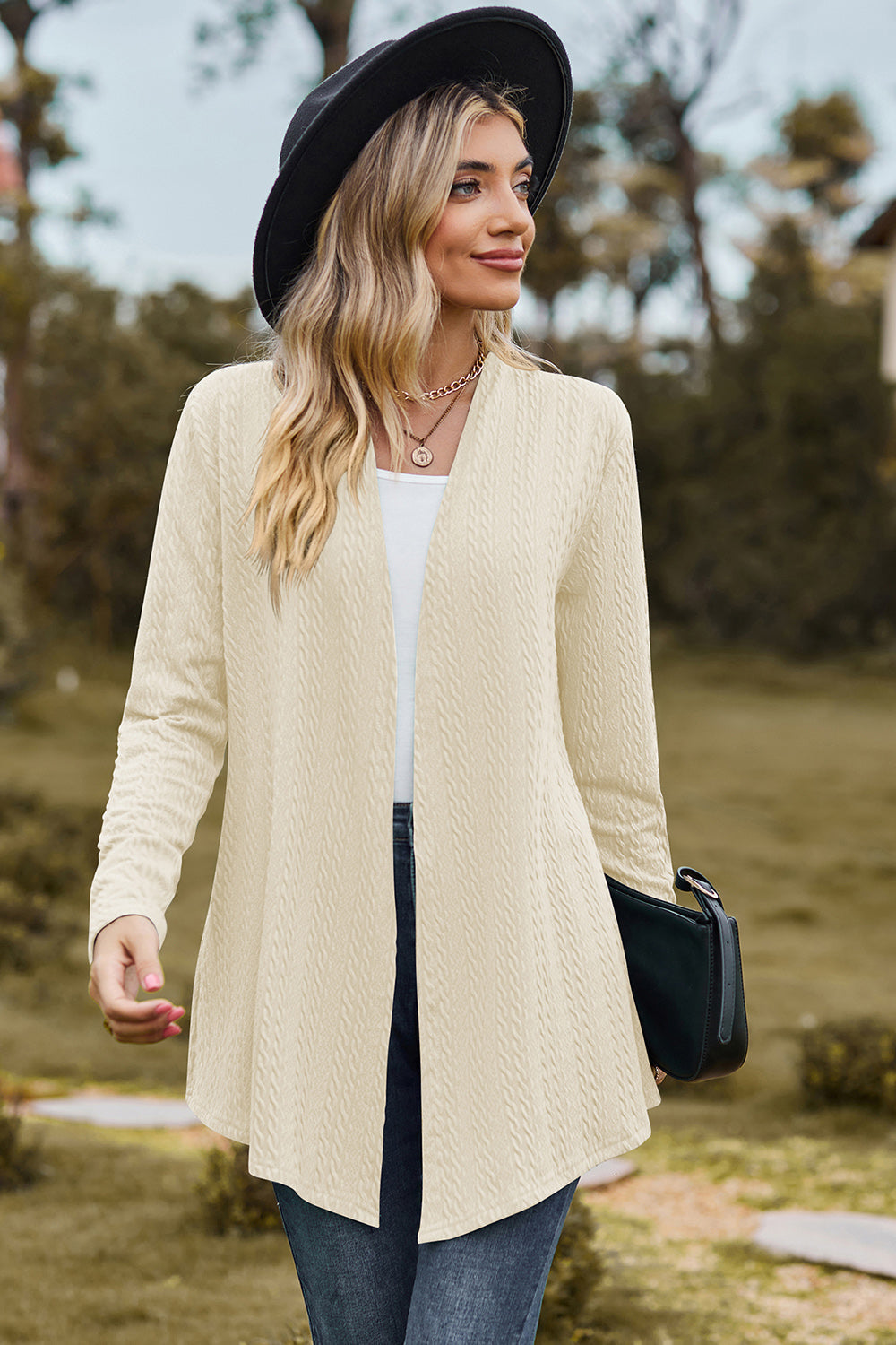 Cream textured open-front drape cardigan with long sleeves and a relaxed fit.