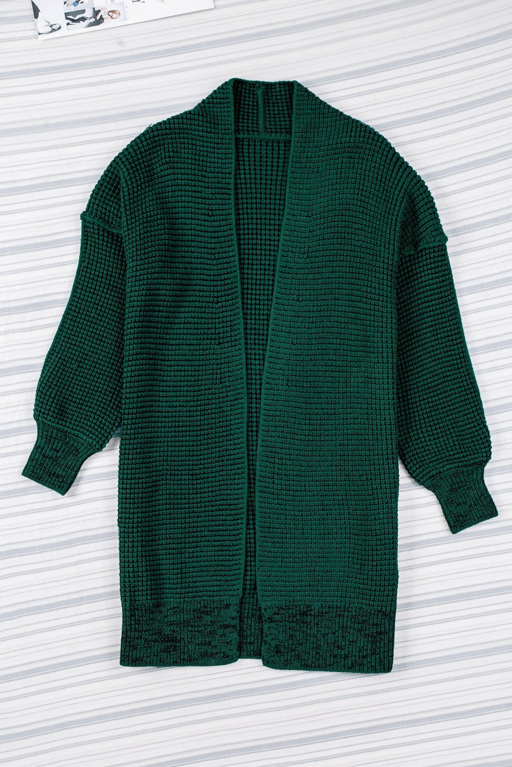 Textured puff sleeve open cardigan in Black Forest green acrylic with waffle knit and ribbed cuffs.