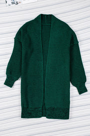 Textured puff sleeve open cardigan in Black Forest green acrylic with waffle knit and ribbed cuffs.