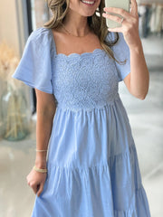 Light blue midi dress with lace bodice, square neckline, and puffed sleeves.