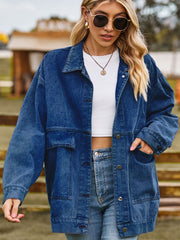 Oversized denim trucker jacket in medium blue wash with collared neck and chest pockets.