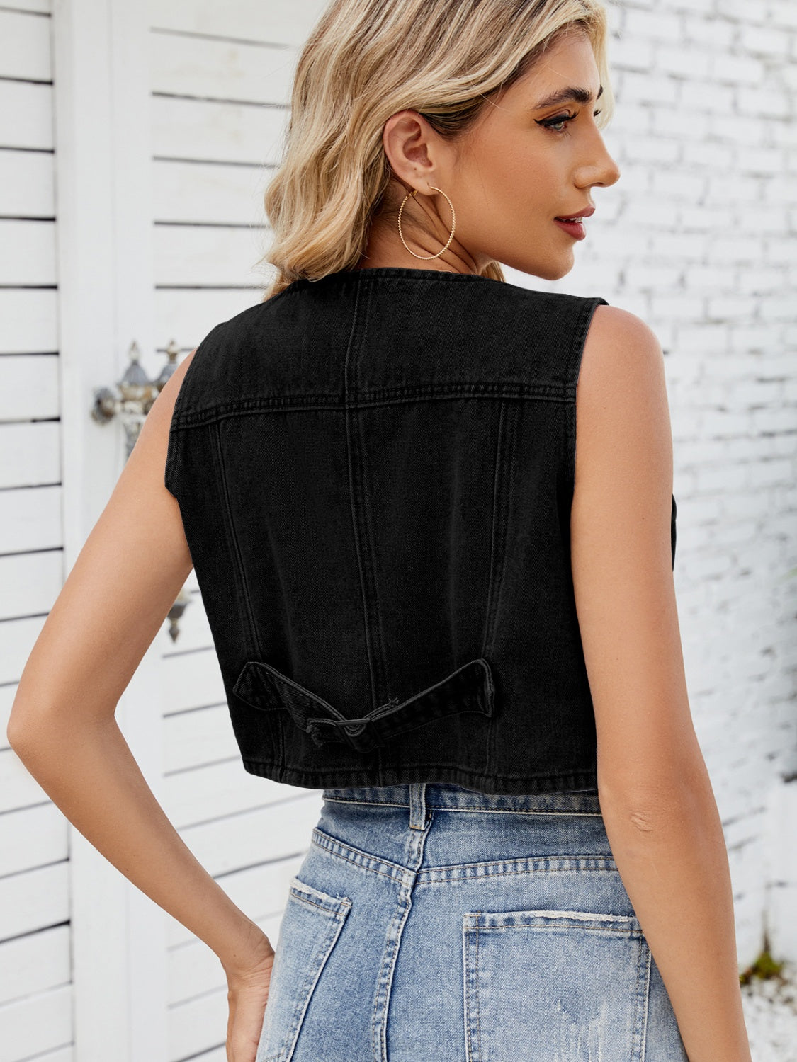 Black cropped denim button-up vest with adjustable back tab