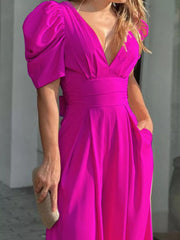 Hot Pink Puff Sleeve Romper with deep V-neck and cinched waist.