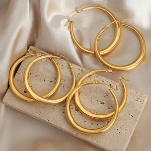 Sculpted oval gold hoop earrings, 18K gold-plated, classic everyday jewelry.