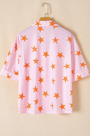 Blush pink pajama top with orange stars, relaxed fit, short sleeves, and collar.