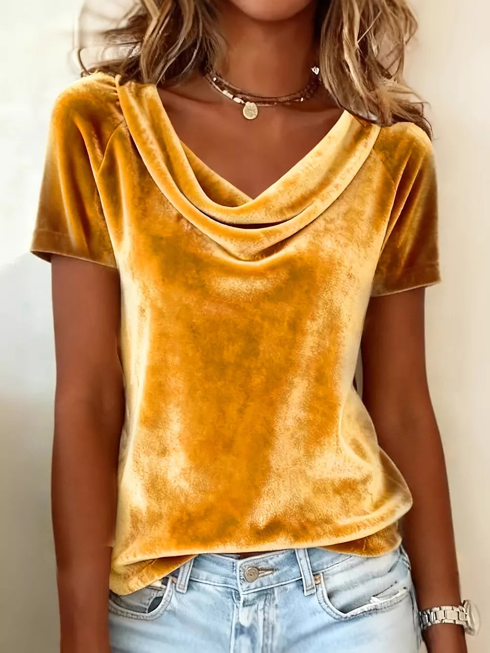 Gold velvet t-shirt with short sleeves and a draped cowl neckline.