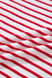 Maternity shirt with red and white stripes, cotton fabric, close-up view of texture.