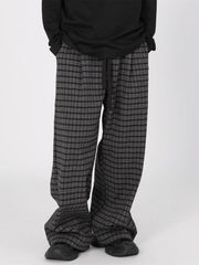 Men's plus size plaid wide leg trousers in grey and black with drawstring waist.