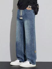 Men's blue wide-leg jeans with drawstring and patch detail