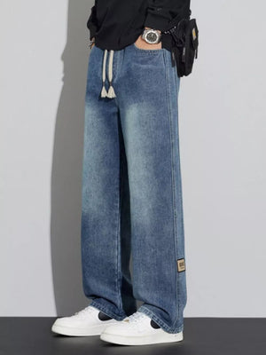 Men's blue wide-leg jeans with drawstring and patch detail
