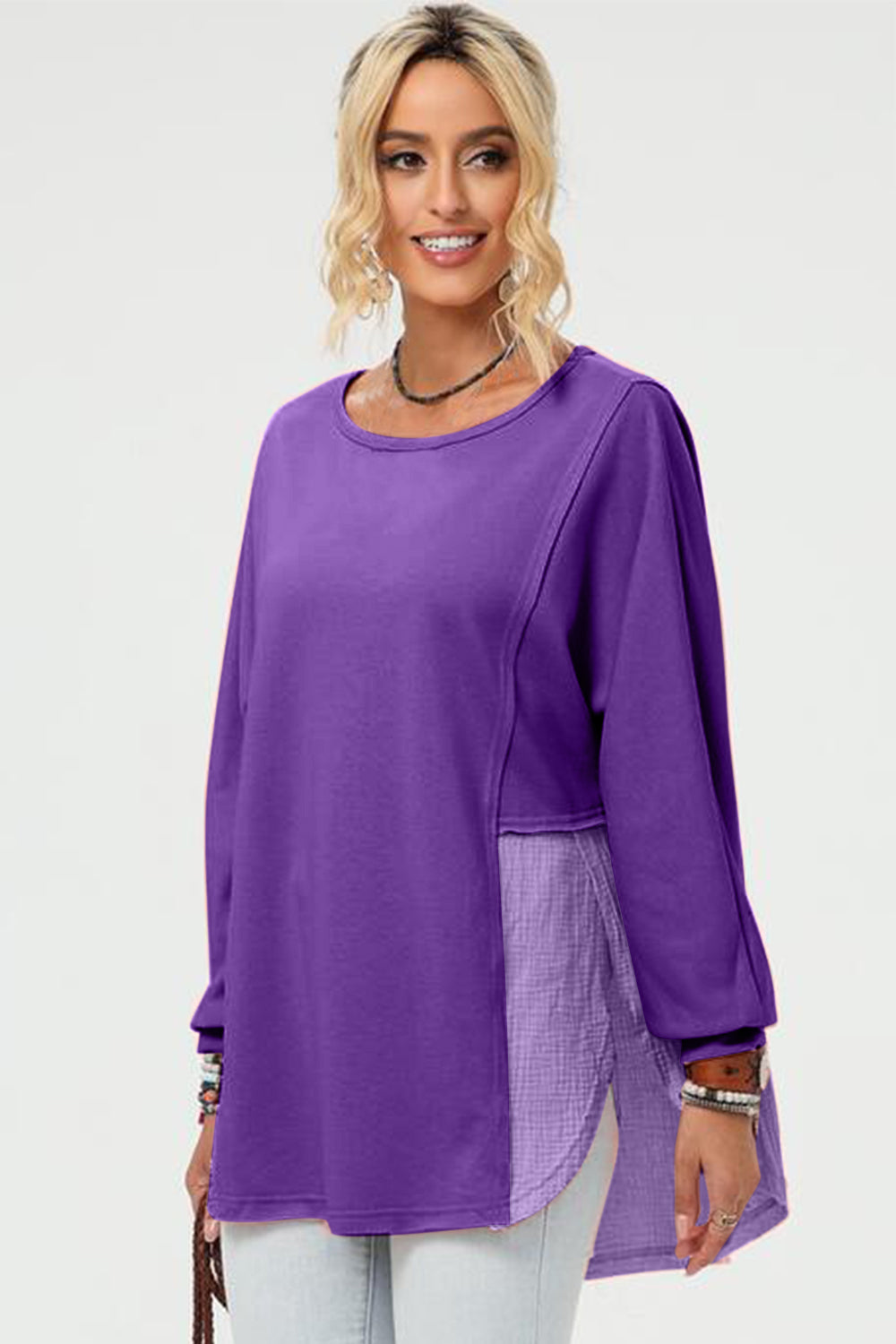 Purple sweatshirt with split panel and asymmetric hemline, featuring a textured fabric insert.