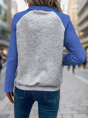 Blue quilted raglan henley sweatshirt with a geometric pattern on the back.