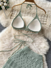 Green crochet halter bikini top with beaded trim and wide-leg pants with diamond pattern.