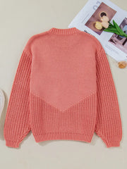Burnt Coral knit sweater with chevron detail and textured sleeves.