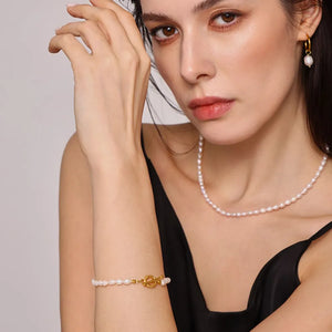 Gold pearl necklace and bracelet set with toggle clasp, and pearl hoop earrings.