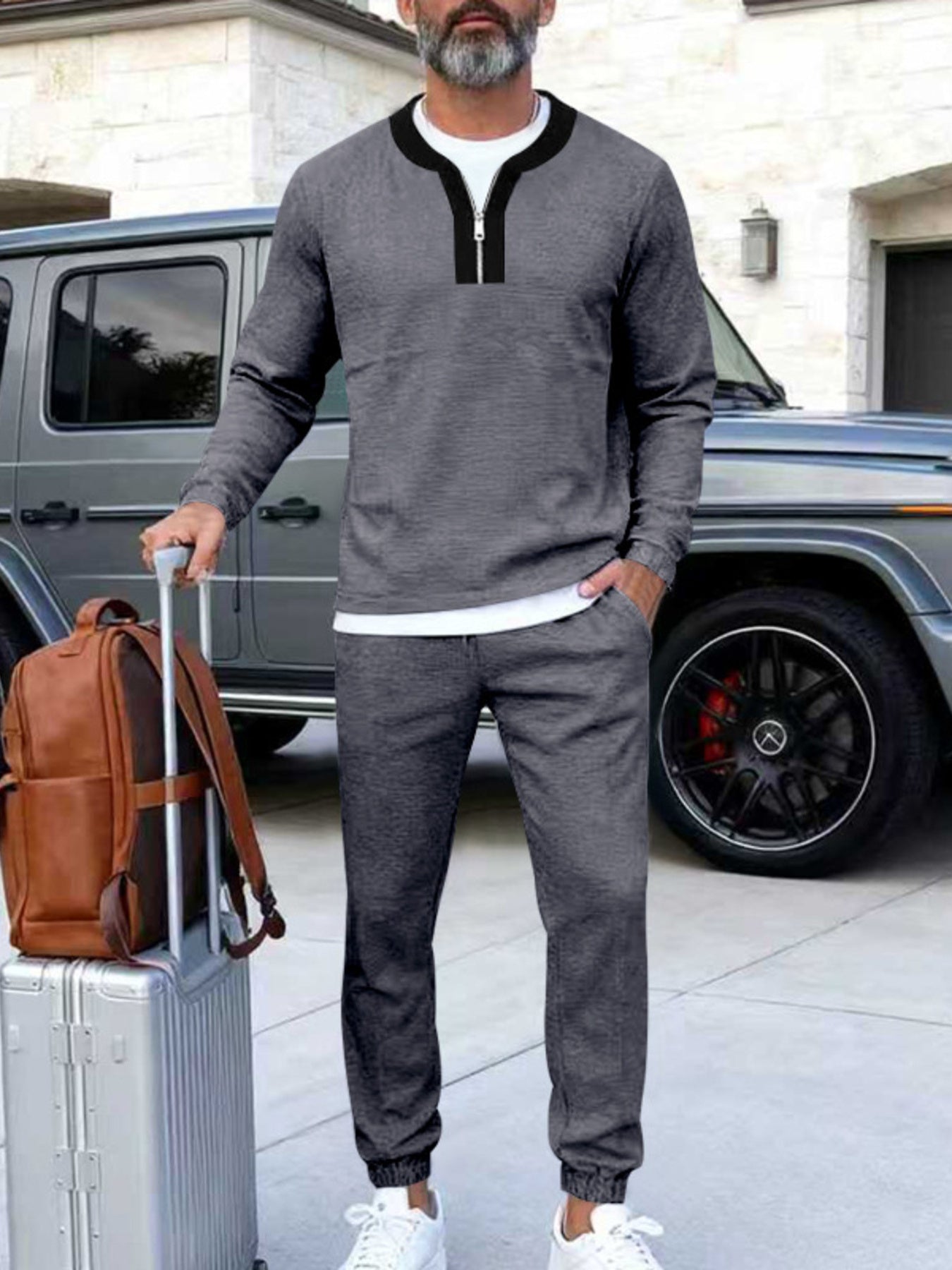 Men's dark gray track pants with a zippered top and black collar detail.