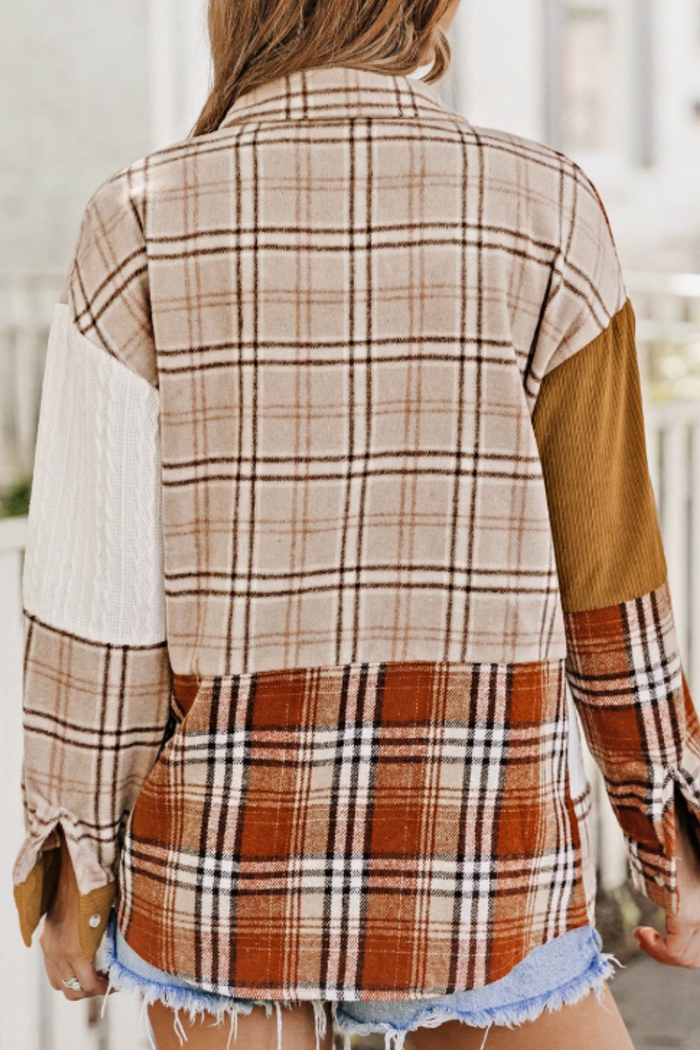Patchwork plaid shacket with mixed textures and colors, featuring a button front and casual cut.