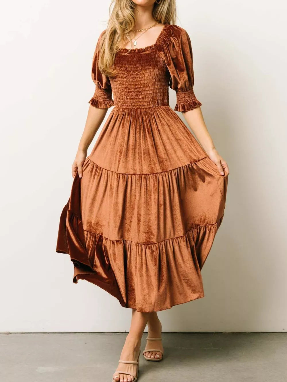 Velvet midi dress in caramel with smocked bodice and ruffled puff sleeves.