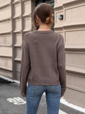 Distressed knit crewneck sweater in coffee brown with ripped details.