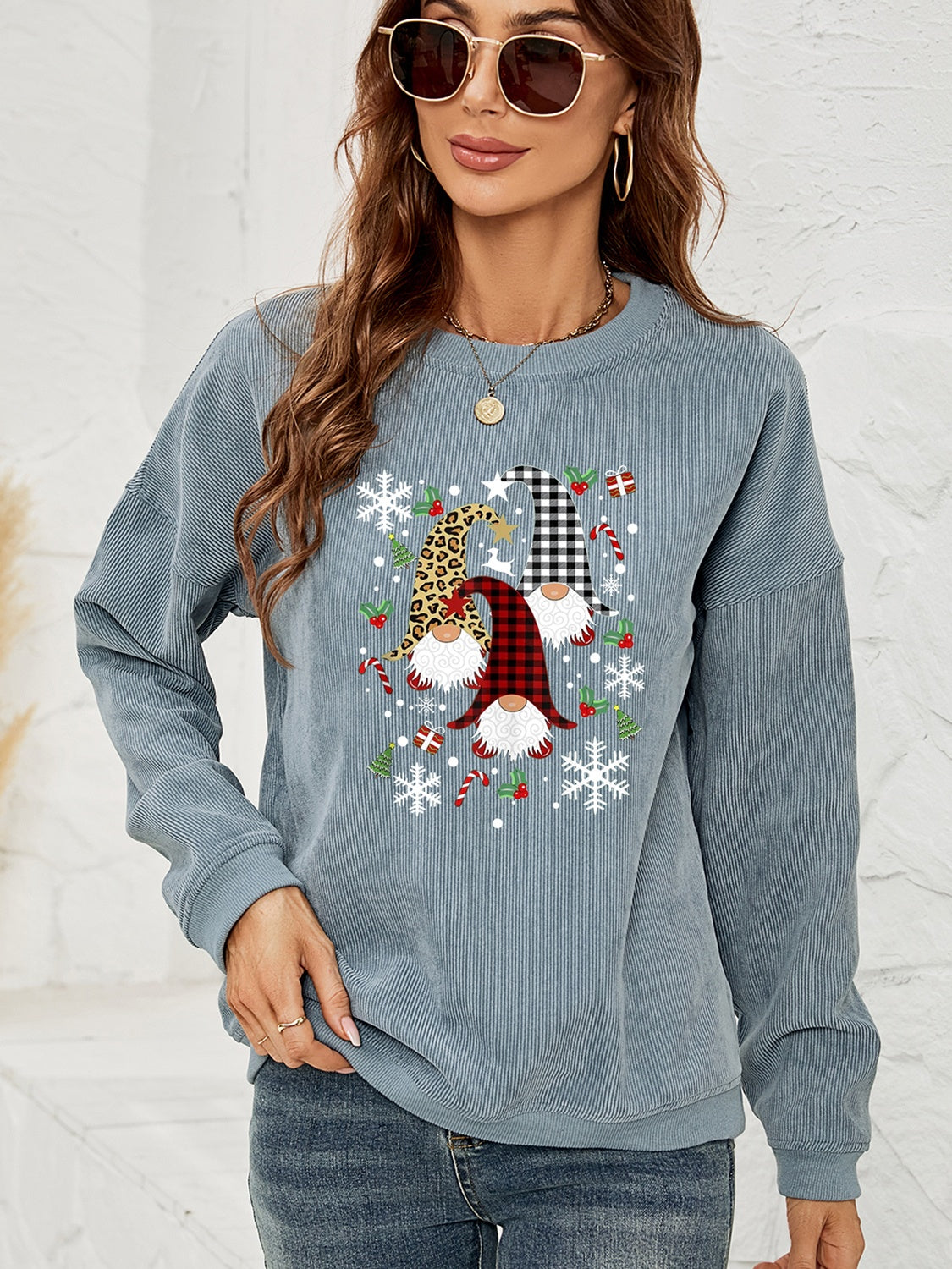 Light Blue corduroy sweatshirt with a gnome graphic featuring plaid and leopard patterns, snowflakes, and candy canes.