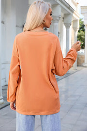 Sherbet corduroy crewneck sweatshirt with ribbed texture and crew neckline.
