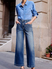 Patch pocket wide-leg jeans in medium wash denim with a faded effect.