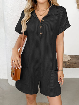 Black ribbed knit romper with collar, buttons, short sleeves, and patch pockets.