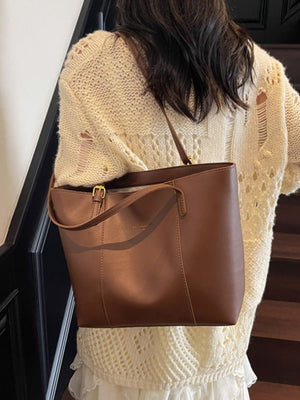 Brown structured pu leather tote bag with gold buckle detail and shoulder strap.