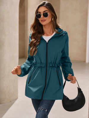 Teal hooded windbreaker jacket with ruffled waistline and drawstring detail