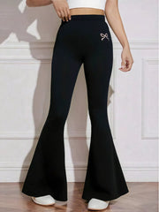 Black flared high-waist active pants with subtle bow emblem detail.