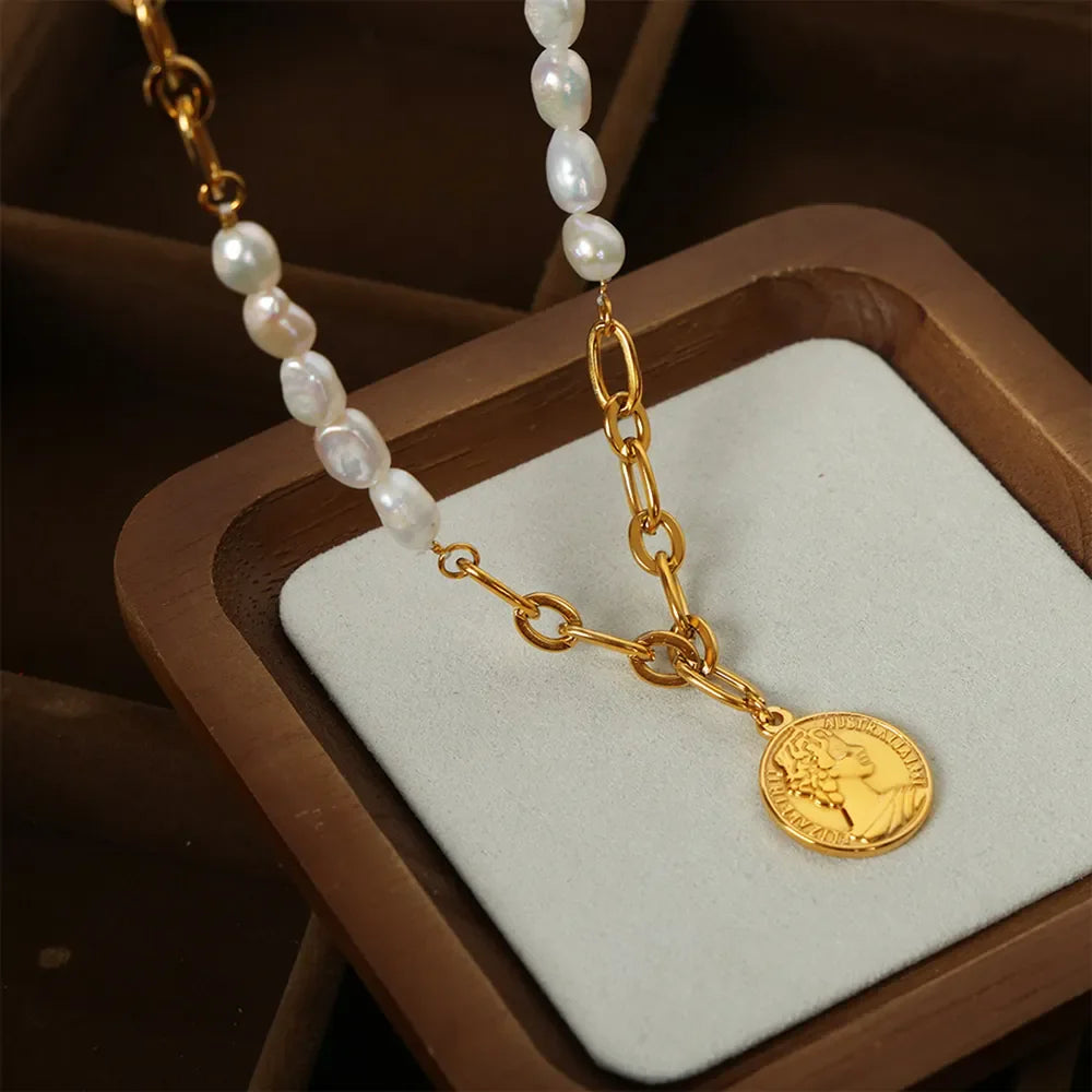 Gold necklace with baroque pearls and a coin pendant.