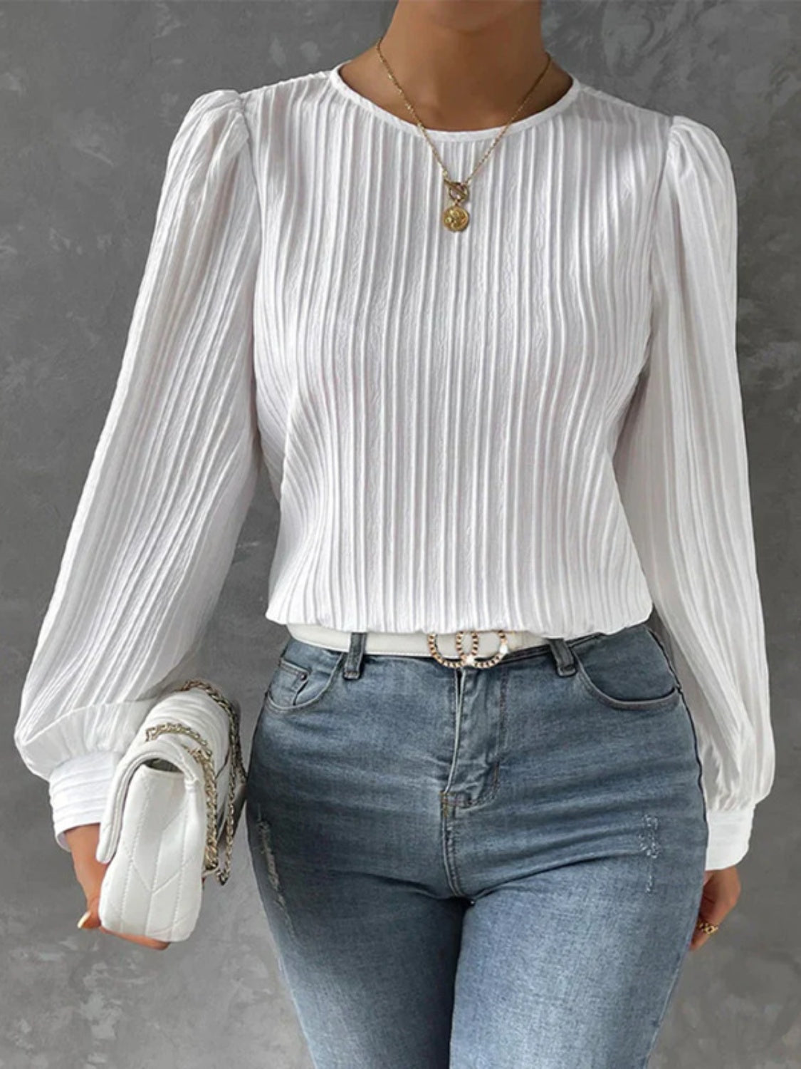 White pleated sleeve blouse with gathered shoulders and crew neck.